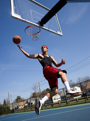 A man playing basketball after visiting shoulder specialist Dr. Matthew Warnock in Houston, TX